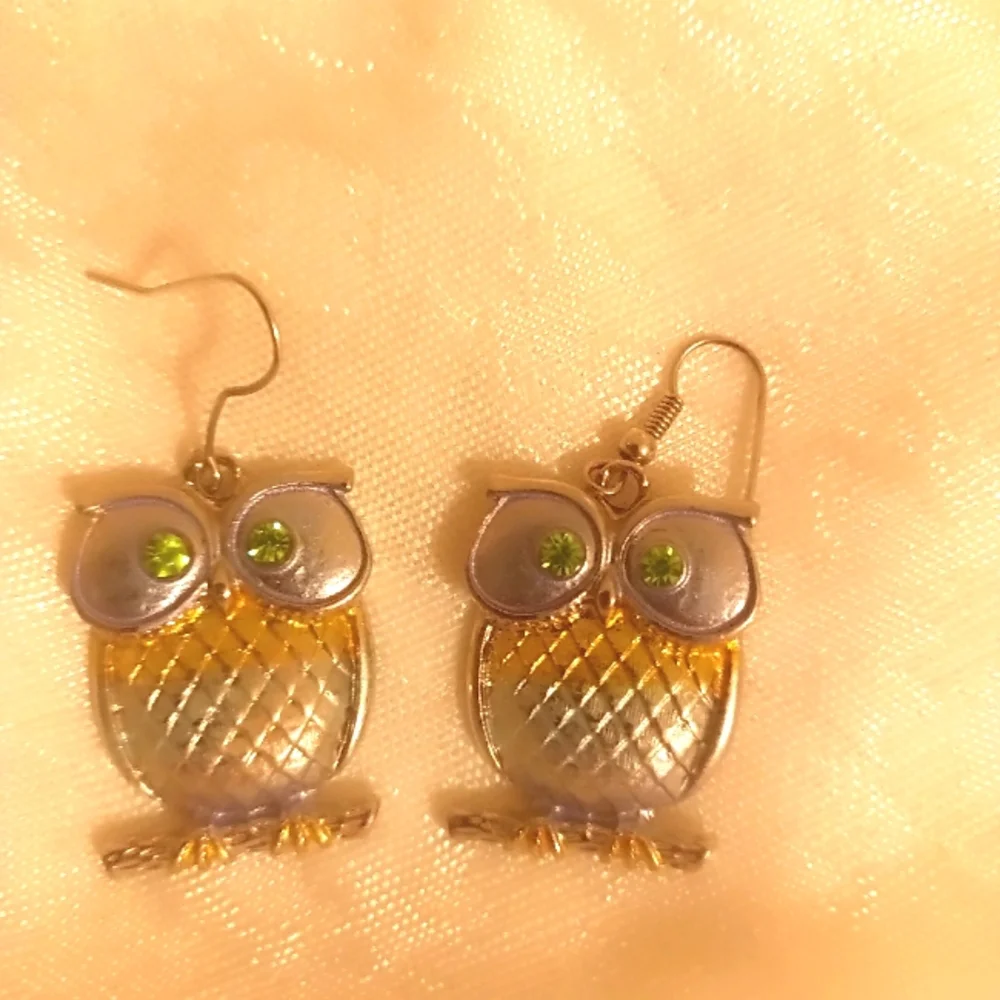 Two toned silver and gold tone green eye owl dangle earrings